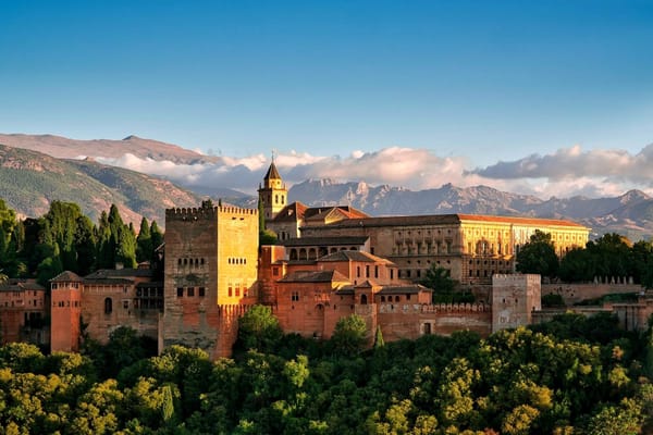The Alhambra rises above Granada as fortress, court, and statement: a city-palace built to govern through position as much as design.